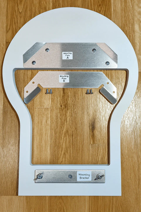 White board with metal brackets on a wooden surface