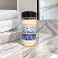 Single bottle of DryFlush Pee Powder on a marble bathroom vanity