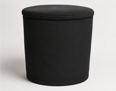 Black round fabric cover with a flat top on a plain background