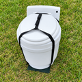 Laveo DryFlush toilet secured in a black carrying harness outdoors