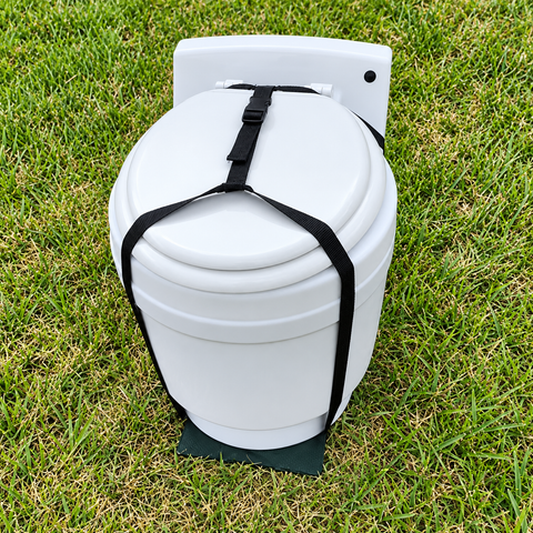 Laveo DryFlush toilet secured in a black carrying harness outdoors